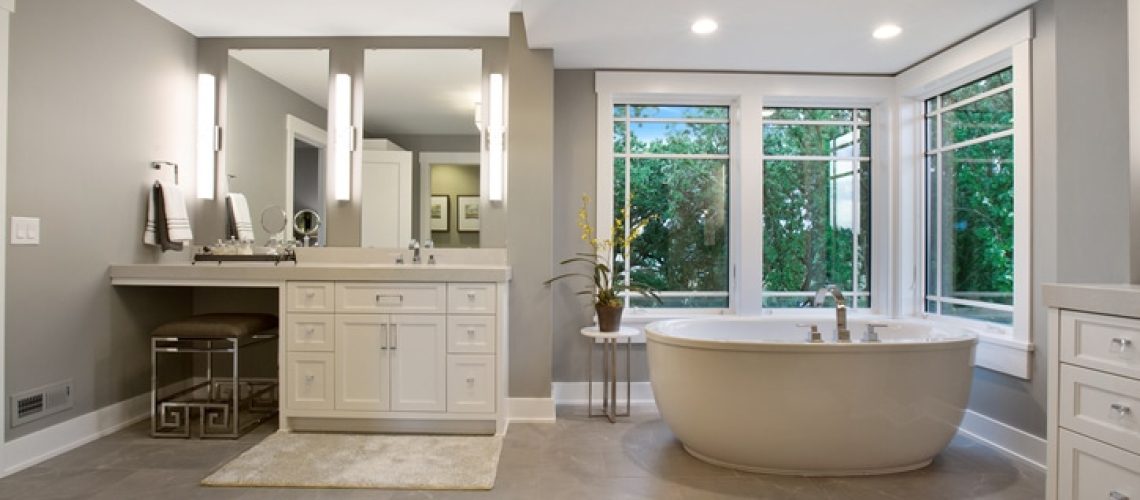 Bathtub surrounded by windows and luxury features inside